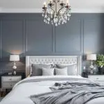 Primary bedroom with a paneled blue accent wall painted in Denver Colorado