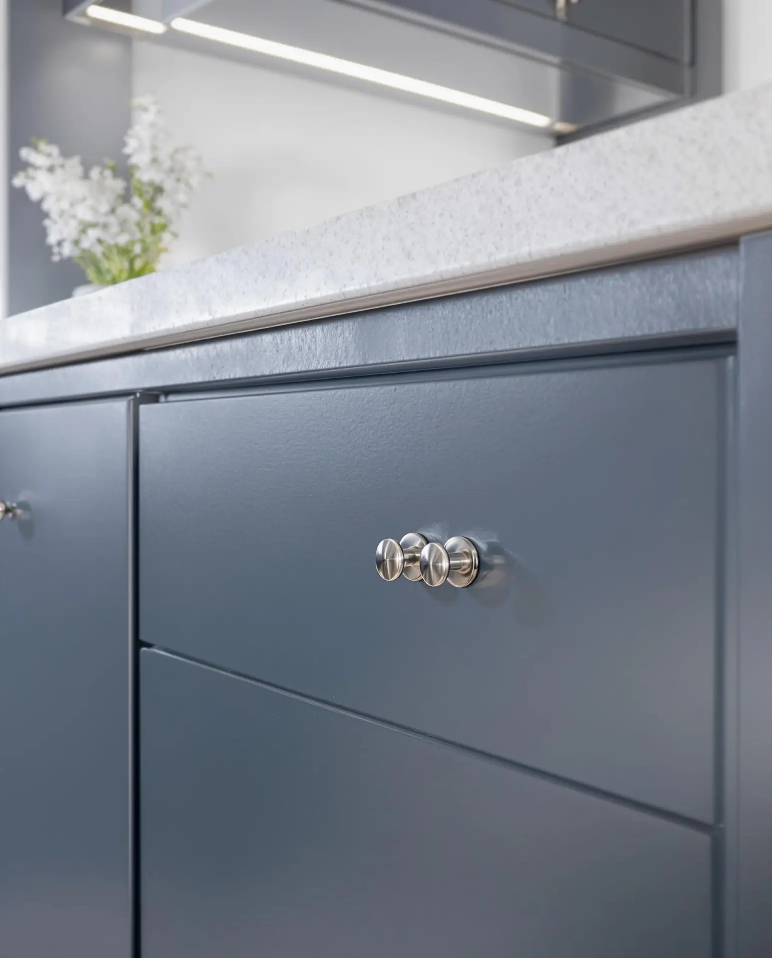 Close up of a smooth navy cabinet drawer front sprayed by Undisputed Painting Services