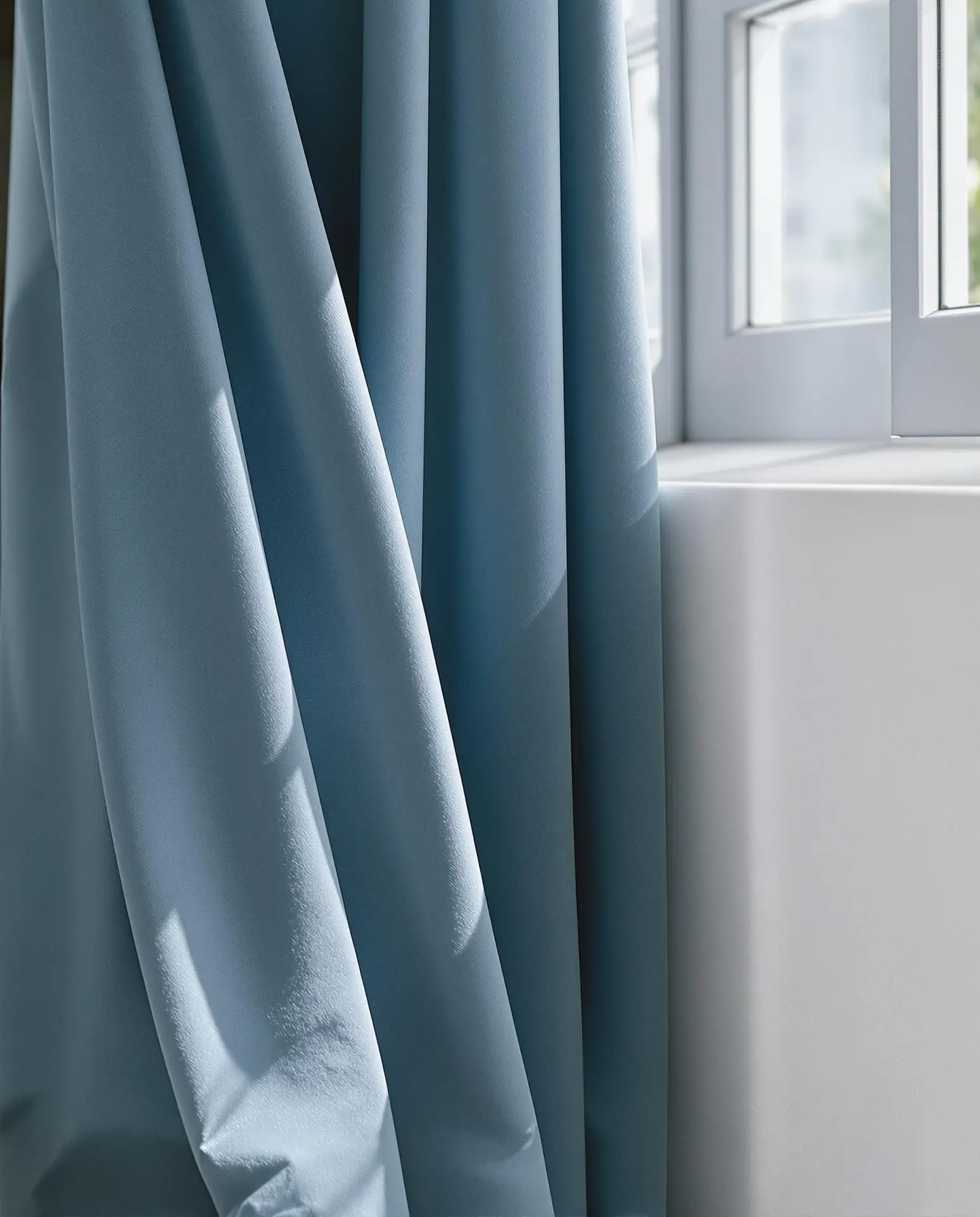 Soft blue drapery and wall color pairing chosen during a color consultation