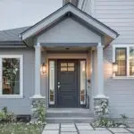 Front entry and porch of a Colorado home with freshly painted siding trim and door