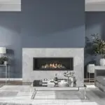Slate blue living room with a marble fireplace freshly painted by Undisputed Painting Services in Denver Colorado