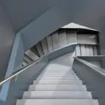 High stairwell walls and railing painted in a soft slate blue in Colorado Springs